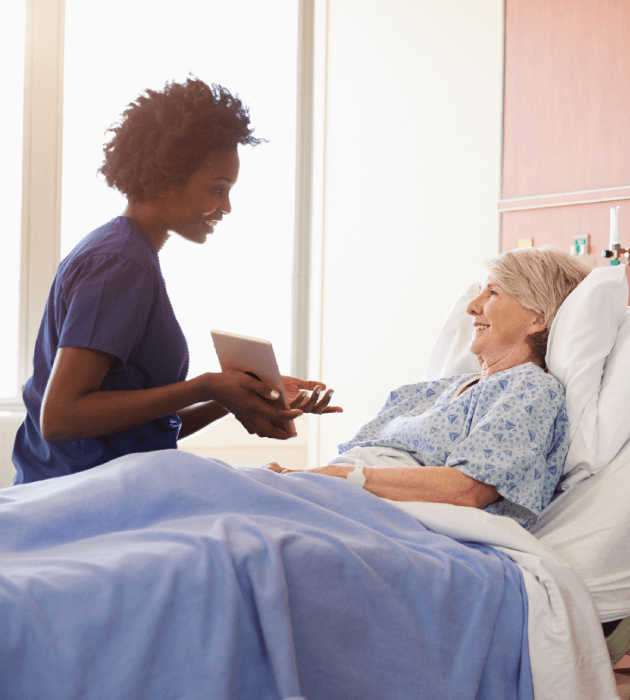 Hospital patient in bed talking with doctor